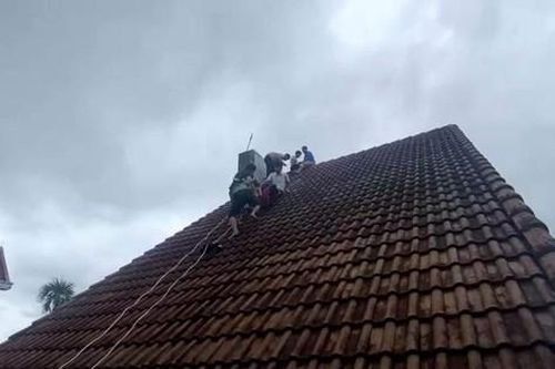 Nghẹt thở cứu nam thanh niên leo lên nóc nhà cao tầng đứng suốt nhiều giờ
