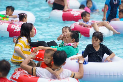 Người TP.HCM tấp nập bơi lội giải nhiệt ngày mùng 2 Tết ở công viên nước Đầm Sen