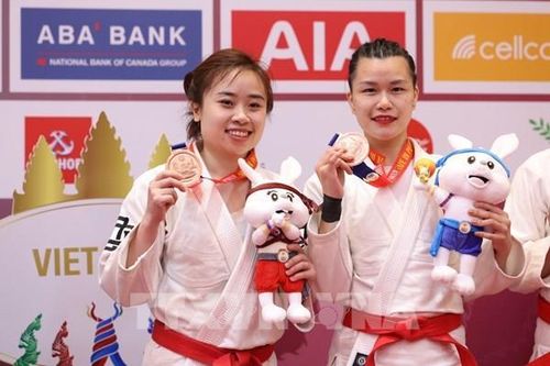 Hai cô gái Việt mang nón quai thao và khăn mỏ quạ lên sàn đấu Jiujitsu SEA Games 32