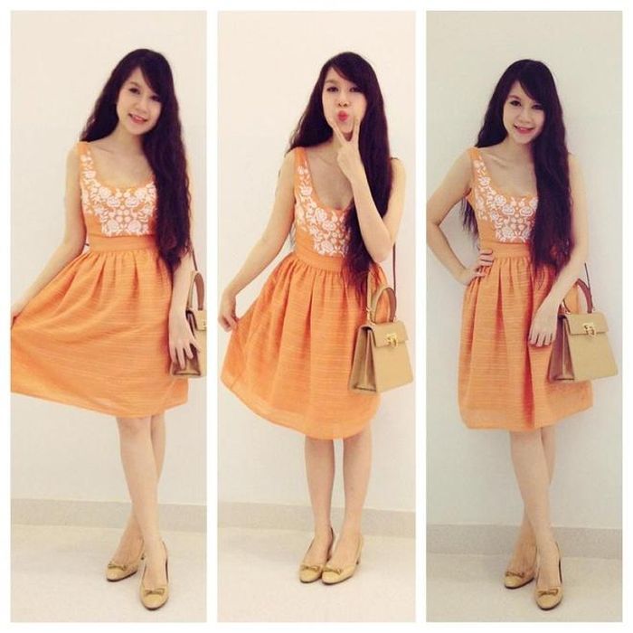 Gam màu cam thuộc list màu yêu thích của Minh Hà. Khoảng thời gian sau khi bé Rio, cựu người mẫu thả dáng trên phố với bộ đầm cam họa điểm nhấn ren ở thân áo trang nhã.