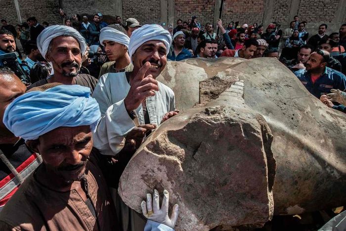 Trong thời gian trị vì, Vua Ramses II từng tiến hành nhiều cuộc viễn chinh, mở rộng lãnh thổ Ai Cập đến Syria về phía đông và đến bắc Sudan về phía nam. Những người kế vị vẫn gọi ông là "ông tổ vĩ đại", "đại đế của các đại đế". Trong ảnh, các công nhân tham gia hoạt động khai quật chụp ảnh cùng tượng Ramses II. Ảnh: Getty.