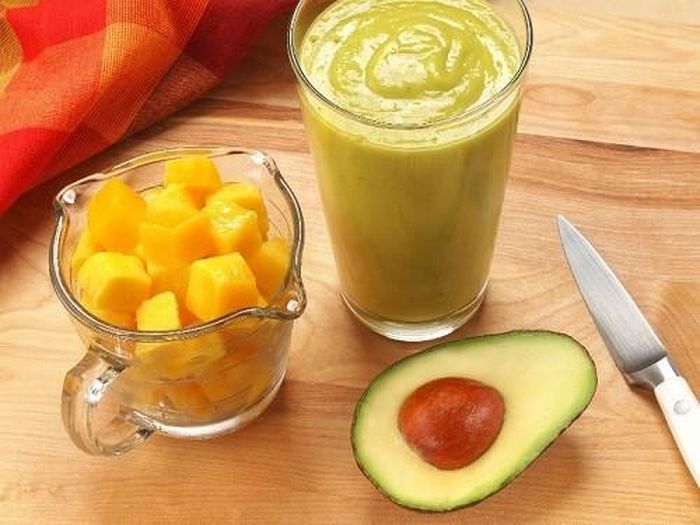 1. Sinh tố xoài bơ. Nguyên liệu: xoài khối, bơ chín, nước ép xoài, sữa chua vani, nước cốt chanh, đường, đá. Cách làm: Cho xoài, bơ, nước ép xoài, sữa chua, nước cốt chanh, đường và đá vào máy xay. Xay cho đến khi mịn thì đổ vào một ly cao. Trang trí với xoài, dâu tây thái lát (nếu muốn) để nhìn đẹp mắt hơn khi thưởng thức. Ảnh: Xaluan.com.