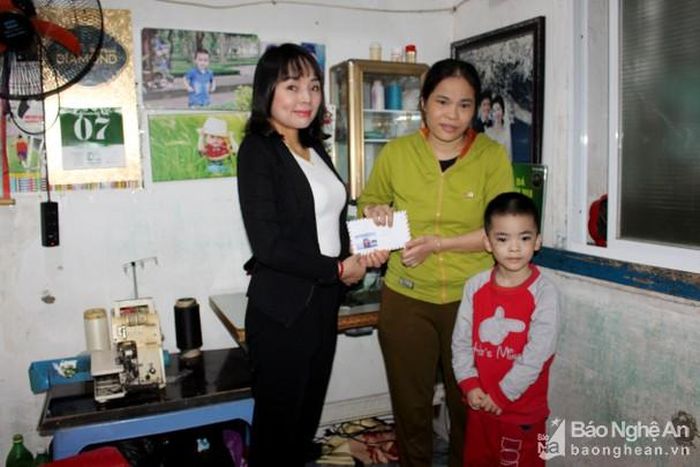 Bà Nguyễn Thị Huyền - Giám đốc Siêu thị Bố Mẹ Bé trao quà hỗ trợ gia đình em Trần Hùng Uy. Ảnh: Nguyệt Minh