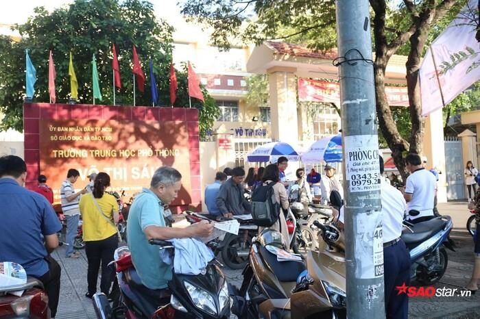 Đọc báo là cách để các phụ huynh “giết thời gian” khi đợi thí sinh thi cử.