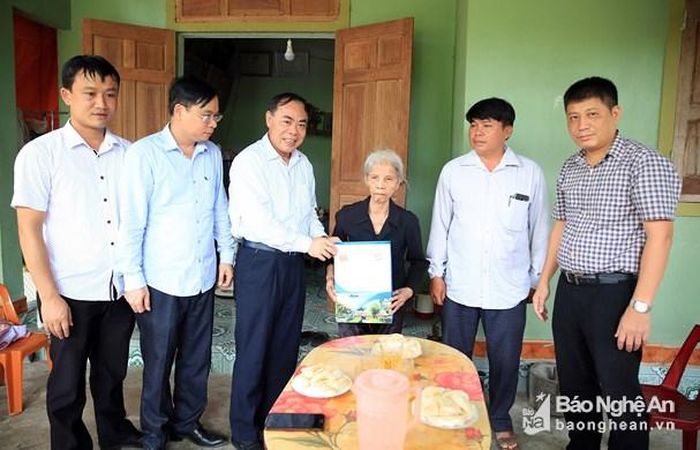 Các đồng chí đại diện Đoàn công tác Sở Du lịch tặng quà cho thương binh, cựu TNXP Nguyễn Thị Mai. Ảnh: Hồ Phương