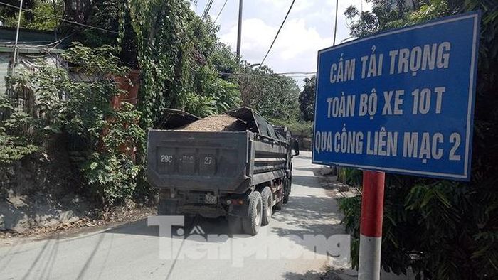 Xe tải hạng nặng tấp nập chạy trên công trình thủy lợi nhiều năm tuổi của phía Tây Hà Nội.