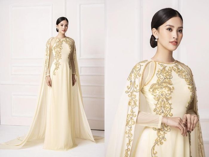 Tiểu Vy trông quý phái trong thiết kế có tông nâu vàng với phần áo choàng voan. Bộ áo dài này được phối họa tiết ở thân áo, chất liệu lụa ánh nhũ mềm mại. Nàng hậu lựa chọn kiểu tóc búi thấp, rẽ ngôi để phù hợp với bộ trang phục mà mình đang mặc.