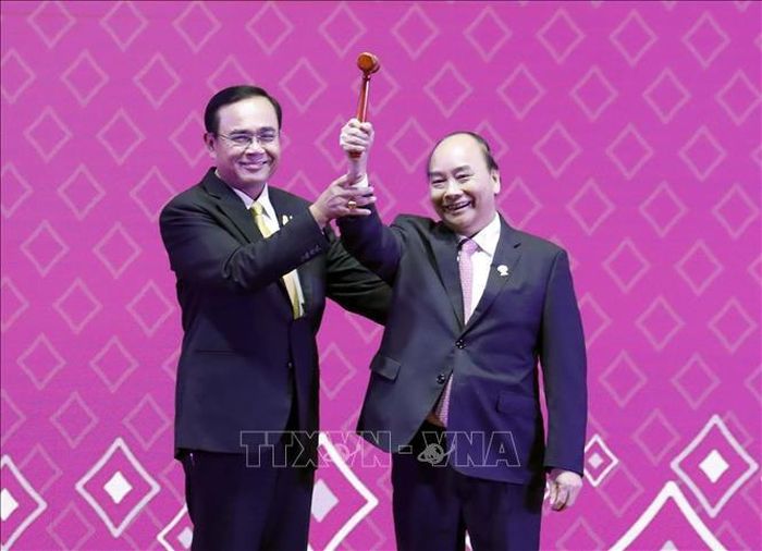 Thủ tướng Nguyễn Xuân Phúc nhận búa Chủ tịch ASEAN từ Thủ tướng Thái Lan Prayuth Chan-ocha. Ảnh: TTXVN.