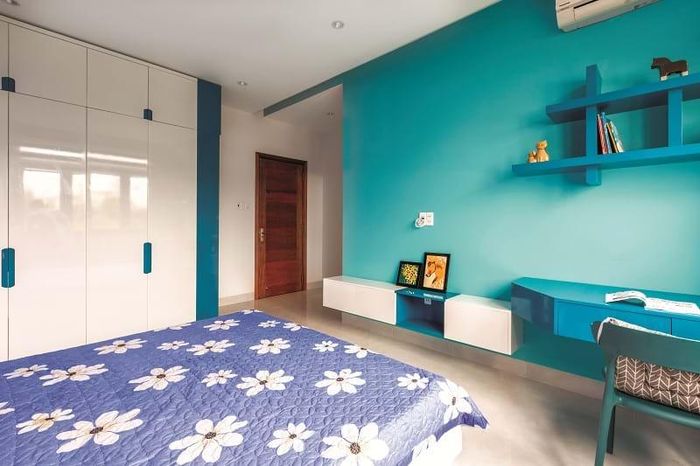 Phòng ngủ với tông màu trẻ trung, cửa mở ra sân vườn nhỏ bên ngoài.
