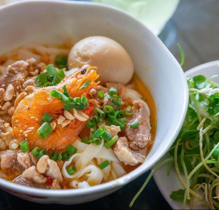 Mì Quảng hấp dẫn bởi cái ngon lành của sự mộc mạc, chân chất đáng quý tựa phong cách sống của người miền Trung. Sợi mì to, thô nhưng đậm và ngậy béo gợi cho người ta cảm giác thảnh thơi khi thưởng thức. Một phần mì đúng điệu thường được chế biến kiểu khô, sợi mì và các phần nguyên liệu hòa lẫn trong chút nước cốt đậm đà. Khi ăn thực khách có thể thưởng thức kèm bánh tráng để cảm nhận trọn vẹn hương vị truyền thống xứ Quảng nói riêng và miền Trung nói chung. Ảnh: Asiancookbooks, Mikepalumbo_.