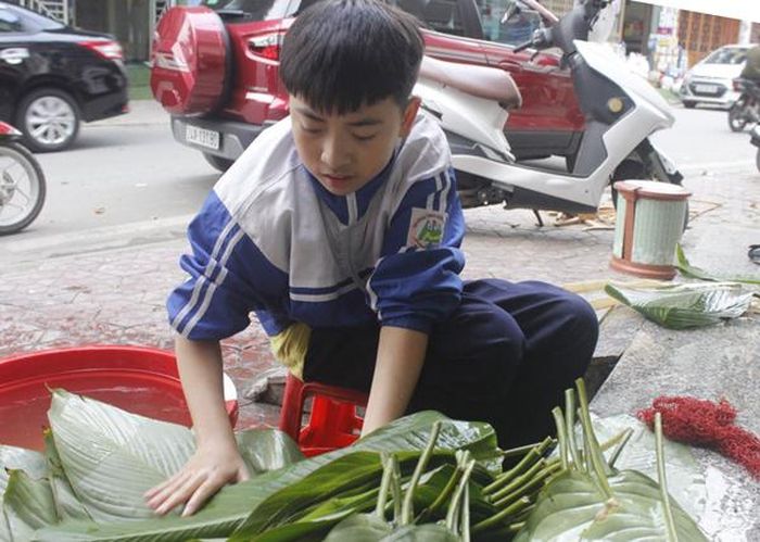 Rửa lá dong chuẩn bị gói bánh.
