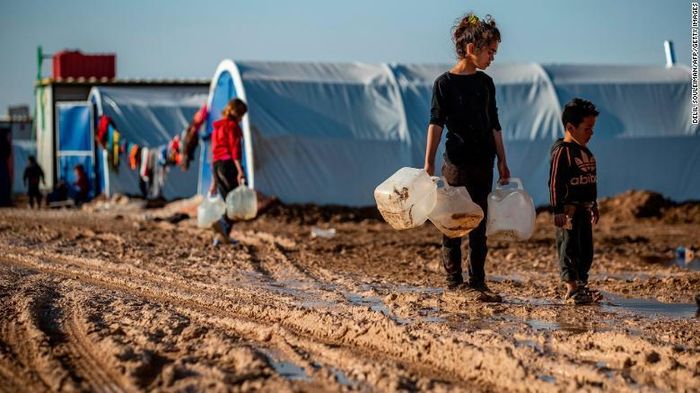 Những đứa trẻ mang theo can để lấy nước ở trại tị nạn Washukanni, Đông Bắc Syria. Ảnh: CNN.