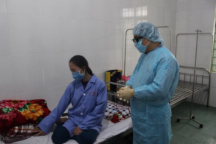 Lãnh đạo Bộ Y tế thăm hỏi bệnh nhân đang được cách ly tại Trung tâm. (Ảnh: Lê Hảo/Vietnam+)