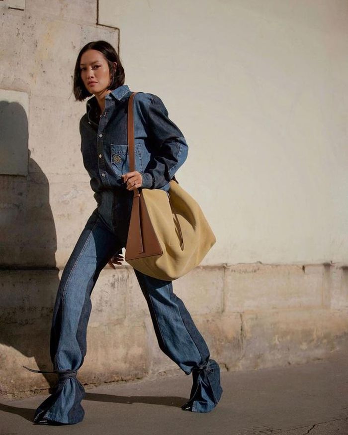 Tín đồ thời trang Tiffany Hsu trông sành điệu và lạ mắt với cách diện trang phục denim hai tông màu của Loewe và tạo điểm nhấn bằng xu hướng dây giày sandals buộc ngoài gấu quần. Những set đồ một sắc thái dễ dàng tạo cảm giác liền mạch và thời trang hơn.