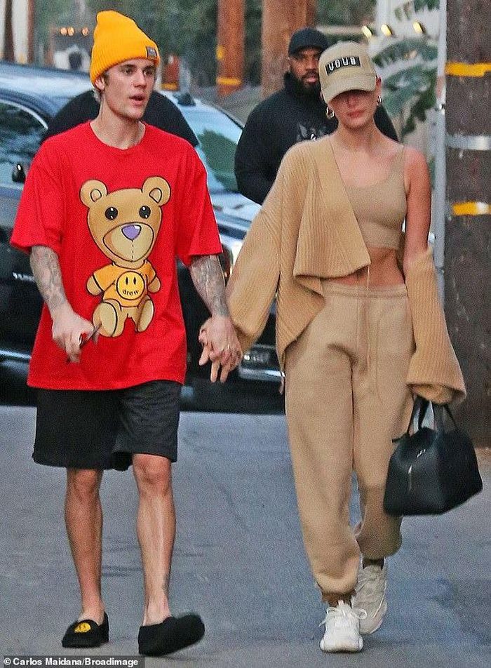 Hôm 18/2, cánh săn ảnh ghi lại cảnh Justin Bieber nắm chặt tay bà xã dạo bước trên đường phố ở West Hollywood (Mỹ). Giọng ca Baby diện bộ đồ rộng rãi với áo phông đỏ và quần short đen. Bên cạnh, Hailey Baldwin trông năng động, cuốn hút với set đồ thể thao. Cô mặc crop-top phối với quần thun cùng màu và đi giày thể thao trắng. 