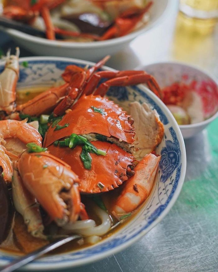 Bạn có thể thưởng thức cua chấm cùng muối tiêu chanh hoặc nước mắm ngâm ớt the cay hấp dẫn. Một tô bánh canh cua nguyên con còn có topping tôm, huyết, chả cá với mức giá chỉ từ 80.000 đồng. Ảnh: Foodholicvn.