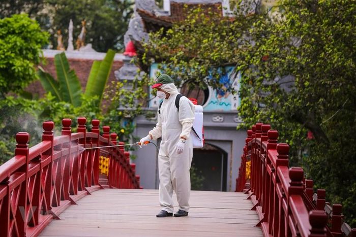 Các nhân viên thuộc ban quản lý đền Ngọc Sơn cũng được yêu cầu thực hiện đầy đủ các khuyến cáo của ngành Y tế về ngăn chặn nguy cơ lây nhiễm dịch. (Ảnh: Minh Sơn/Vietnam+)