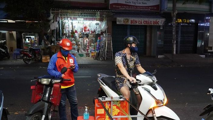 Khách đợi bên ngoài để nhận đồ ăn từ ròng rọc di chuyển ra. Ảnh: NGUYỄN TIẾN