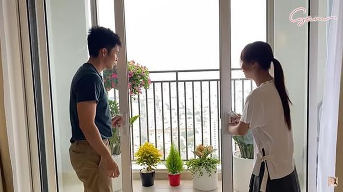 Ban công được trồng nhiều cây cảnh. Từ góc này có thể nhìn sang quận 2, quận 7. Cô dự định bày thêm một bộ bàn ghế ngoài ban công để thư giãn lúc rảnh.