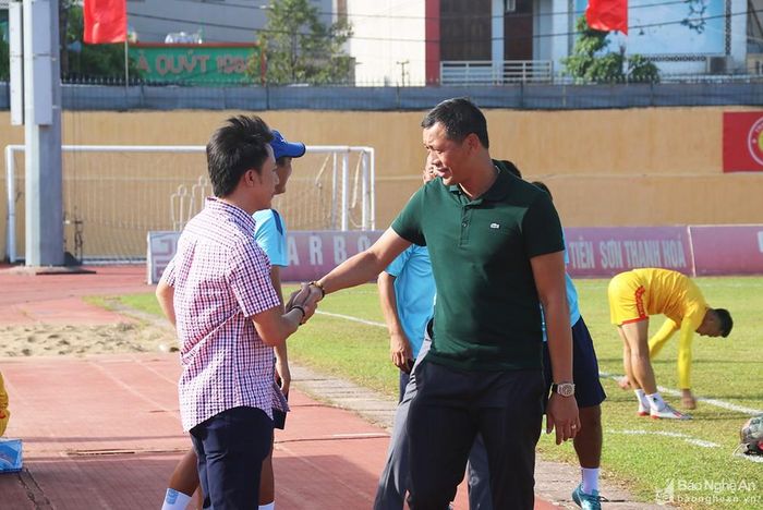 Giám đốc kỹ thuật Nguyễn Đức Thắng của SLNA và HLV Nguyễn Thành Công chào hỏi nhau trước trận đấu. Cả hai đều trưởng thành từ đội bóng xứ Nghệ. Ảnh: Trung Kiên