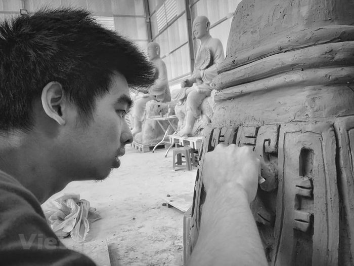 ...rồi đắp nổi họa tiết, tạo hình khối điêu khắc trang trí. (Ảnh: Xuân Mai/Vietnam+)