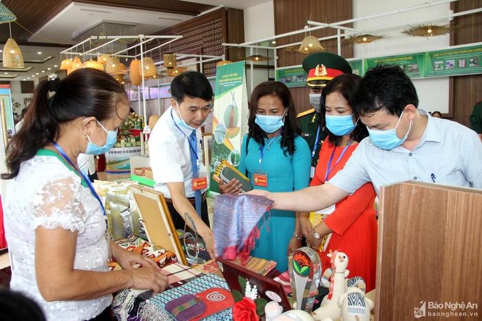 Khách hàng tham quan gian hang thổ cẩm Quỳ Châu ở thành phố Vinh tại Hội nghị Thi đua yêu nước. Ảnh: Quang An