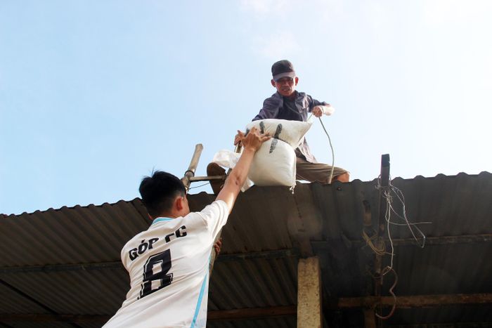 Người dân làng biển Phước Thiện huy động bao cát để chèn chống nhà cửa