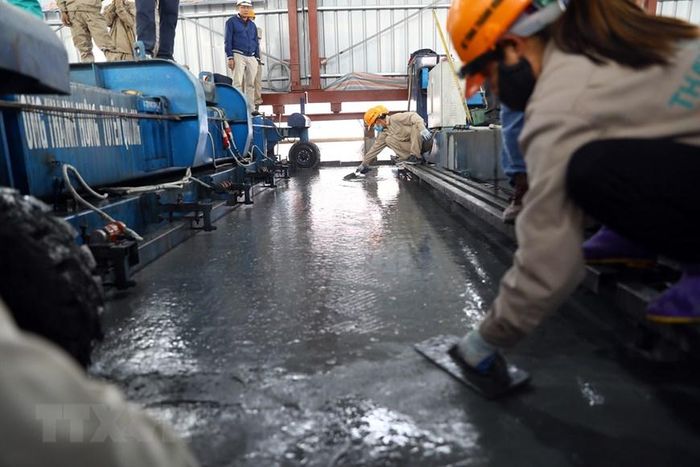 Đổ lớp bê tông siêu tính năng UHPC. (Ảnh: Huy Hùng/TTXVN)