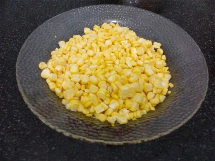 Bắp lột vỏ, bẻ đôi, đặt đứng lên thớt, dùng dao cắt theo chiều dọc, tách rời các hạt.