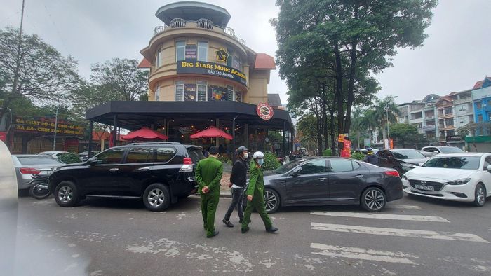 Lực lượng chức năng nhắc nhở khách thực hiện giãn cách tại 1 quán cà phê ở Hà Đông - Ảnh: M.Đ