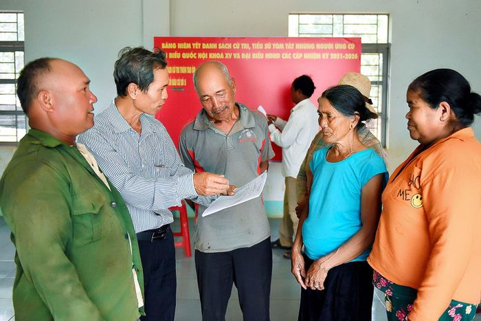 Ông Nay Ky (thứ 2 từ trái qua)-Chủ tịch Ủy ban MTTQ Việt Nam xã Ia Rong, huyện Chư Pưh tuyên truyền về cuộc bầu cử cho người dân làng Tao Ôr.