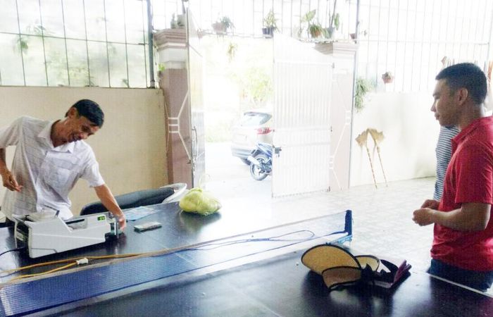 Đếm tiền bằng máy ngay sau khi đã thương lượng giao dịch đất nền xong ở Quỳnh Lưu. Ảnh: Văn Trường.