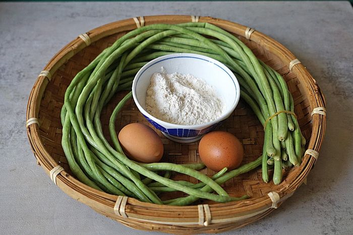 Nguyên liệu: 400g đậu đũa, nửa bát con bột mì, 2 quả trứng, 1 thìa cà phê muối, chút tiêu. Bước 1: Chuẩn bị đậu đũa, bột mì, trứng và các nguyên liệu khác trước. Lưu ý: Đậu đũa phải tươi và mềm.