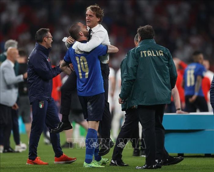 Hậu vệ Italy Leonardo Bonucci chúc mừng HLV Roberto Mancini sau khi đội nhà đánh bại tuyển Anh và đăng quang vô địch EURO 2020 trên sân Wembley ở London, ngày 11/7/2021. Ảnh: AFP/TTXVN