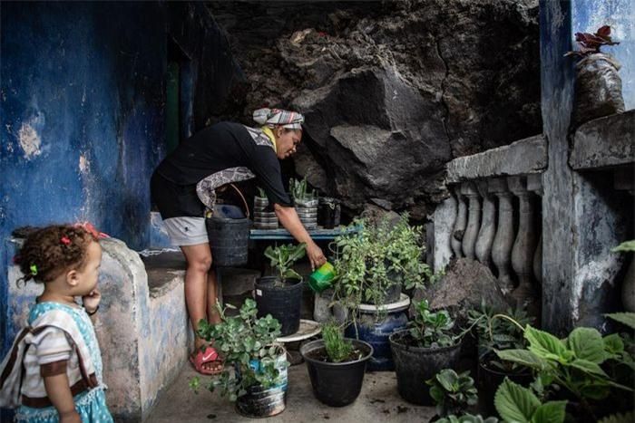 Djennifer Barbosa đang tưới cây trên sân thượng, nơi từng bị dòng dung nham nhấn chìm một lần. "Dung nham đã tràn vào bên trong ngôi nhà. Sau vụ phun trào, thật không dễ dàng để tôi quyết định tiếp tục sống ở đây. Ban đầu, nó để lại khoảng tối trong lòng tôi. Nhưng tôi không còn sự lựa chọn. Thế rồi, mọi thứ dần trở nên bình thường", Djennifer chia sẻ.