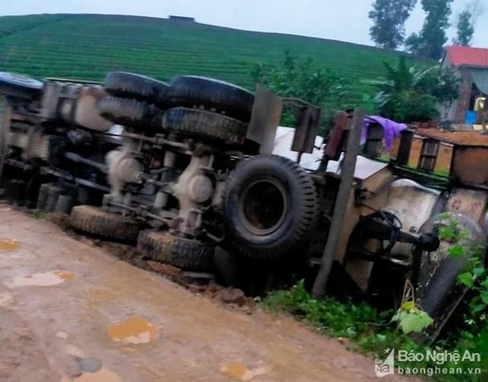 Chiếc xe lật nghiêng trong mưa. Ảnh: Huy Thư