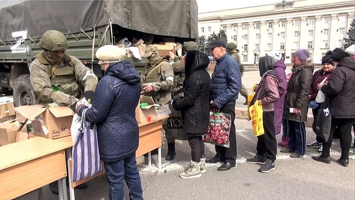 Quân đội Nga phân phát viện trợ nhân đạo cho người dân ở Kherson. Ảnh: TASS.