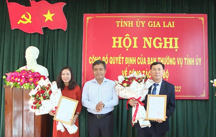 Bí thư Tỉnh ủy Hồ Văn Niên (ở giữa) tặng hoa, trao Quyết định của Ban Thường vụ Tỉnh ủy cho đồng chí Lê Thị Thanh Mai (bìa trái) và đồng chí Bùi Văn Khánh. Ảnh: Ngọc Minh