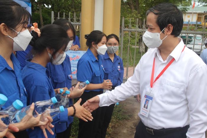 Bộ trưởng gặp gỡ các tình nguyện viên bên ngoài điểm thi.