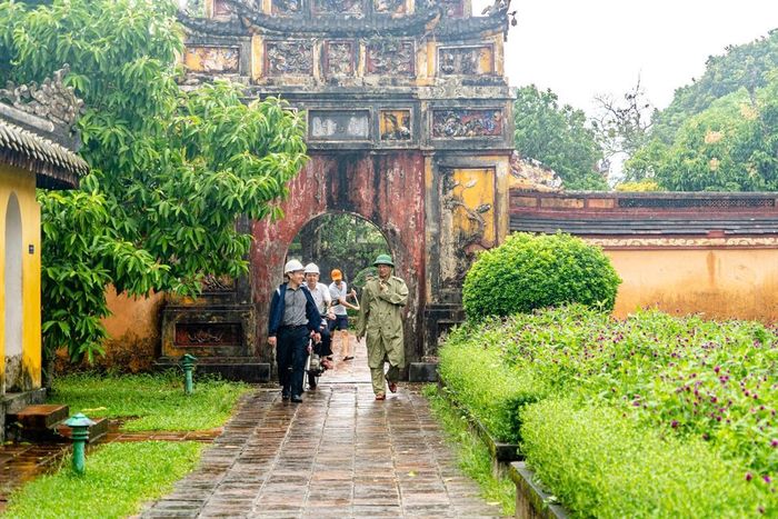 Ông Hoàng Việt Trung (bìa phải) - Giám đốc Trung tâm BTDTCĐ Huế - đi kiểm tra các công trình di tích tại Đại nội Huế sau bão. Ảnh: Bảo Minh