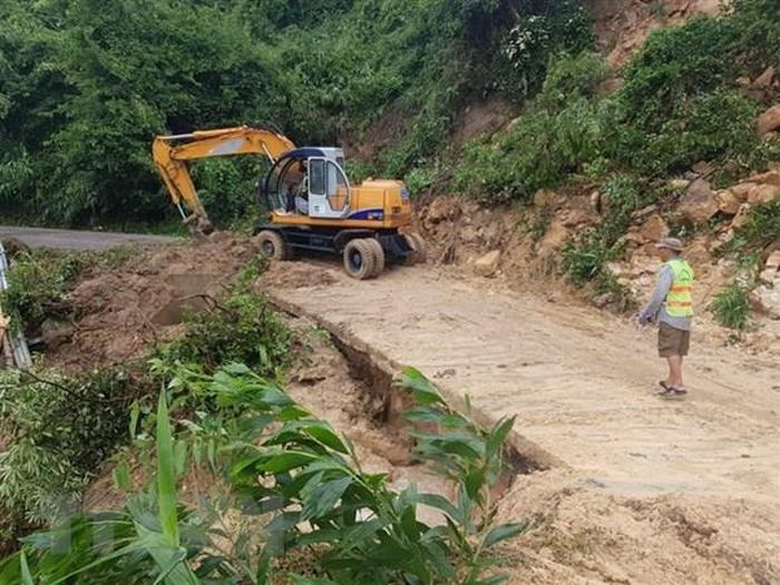 Khắc phục sạt lở do bão trên tuyến ĐT 611. Ảnh: Hữu Trung/TTXVN