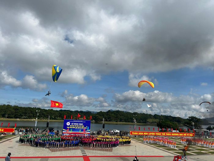 Biểu diễn dù lượn có động cơ kéo quốc kỳ và cờ đại hội