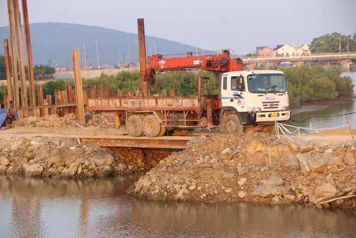 Đường công vụ đắp chắn ngang sông đã khiến dòng chảy bị ách tắc. Ảnh: Tiến Đông