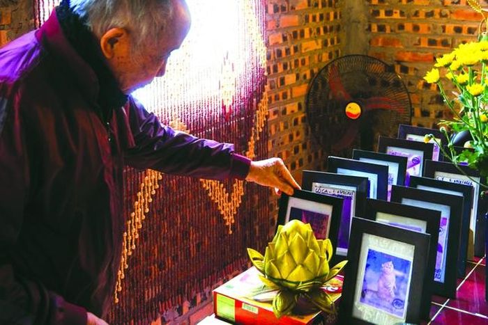 Nhà thơ Bảo Sinh bên bài vị của những chú mèo