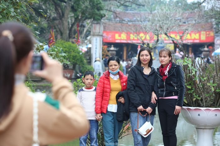 Hoàn thành việc dâng lễ, cúng bái, du khách tranh thủ chụp ảnh, lưu giữ kỷ niệm tại khu Di tích đền Trần. Ảnh: TRỌNG TÀI.
