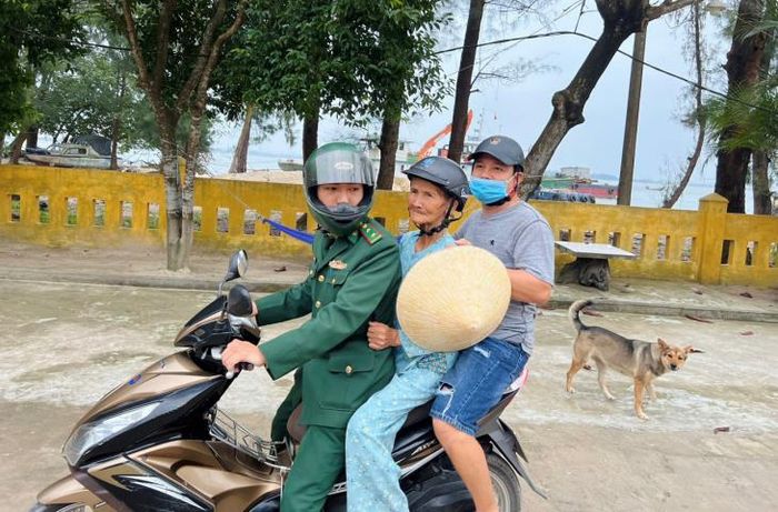 Cán bộ Trạm kiểm soát Biên phòng Thuận An đưa cụ về nhà. Ảnh: Võ Tiến