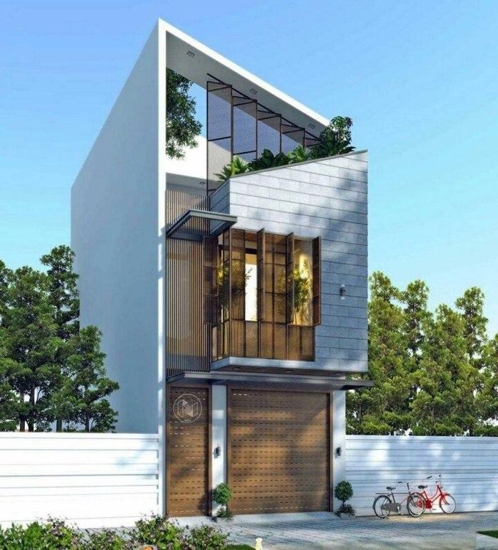 Nhà phố mái lệch kết hợp mảng tường lệch bắt chéo vô cùng nổi bật. Thêm vào đó, các khung cửa với màu sắc khác biệt tạo các mảng hình khối rõ rệt, ấn tượng và bắt mắt. (Ảnh: Vietnamarch)