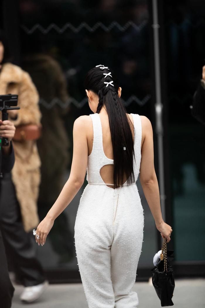 Jennie tại fashion show của Chanel đầu tháng 3 vừa qua đã mang đến kiểu tóc tết độc lạ, và ngay lập tức tạo trend. Cô nàng để tóc tết đơn, sử dụng 1 bím tóc tết đặt ở phía đặt trước. Phần tóc còn lại được chải gọn về phía sau, chải ép sát đầu đi kèm dải nơ nhỏ màu trắng. Phần tóc xõa từ gáy đổ xuống được nhấn nhá thêm 1 lọn tóc tết nhỏ đặt ở chính giữa. Kiểu tóc này rất hợp với các nàng có phom đầu nhỏ mà tròn như Jennie, tạo cảm giác phóng khoáng vô cùng hiện đại