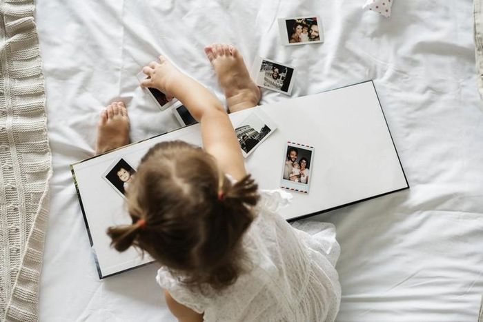 Hãy để con tìm hiểu về những thành viên trong gia đình và bạn bè yêu quý chúng bằng cách cho chúng xem ảnh trong album. (Ảnh: ITN).