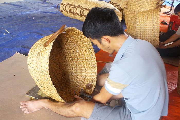 Một thợ đan lục bình đang hoàn thiện công đoạn cuối cùng của sản phẩm lục bình trước khi đem đi xuất bán ra thị trường nước ngoài